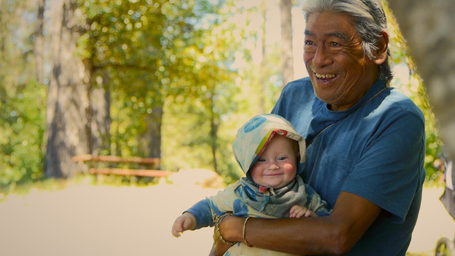 An elder laughing with a baby